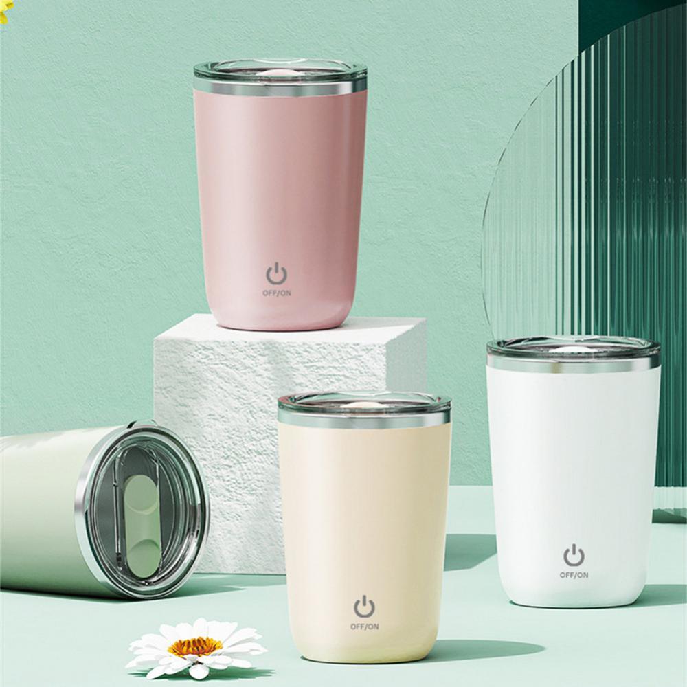 Four AutoMug Pro™ cups in pink, beige, white, and green on pastel display
