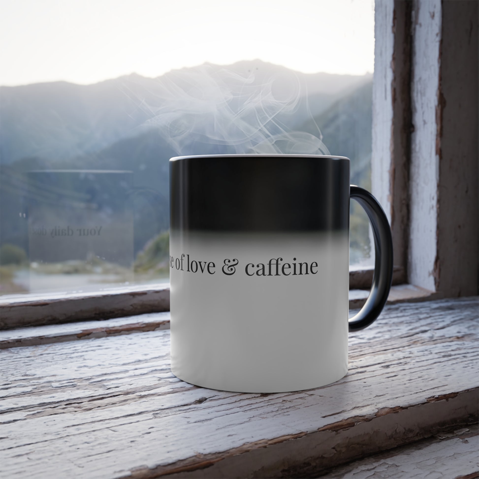 Color changing mug with 'Your daily dose of love & caffeine' design revealing with steam on a windowsill